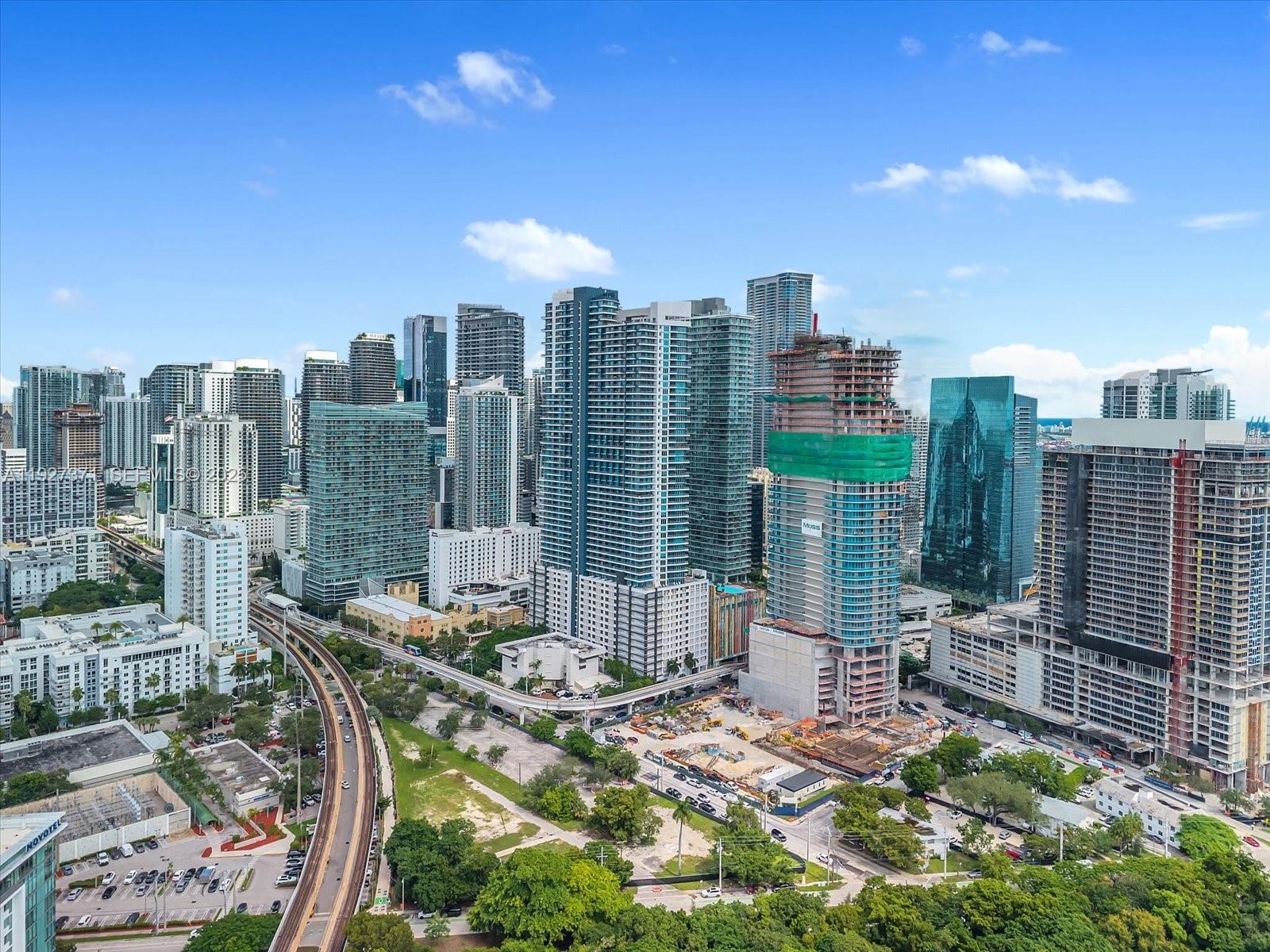 An aerial view of the Miami skyline featuring high-rise buildings and a construction site — 40 SW 13th St # 202, Miami FL 33130, MIAMI, FL