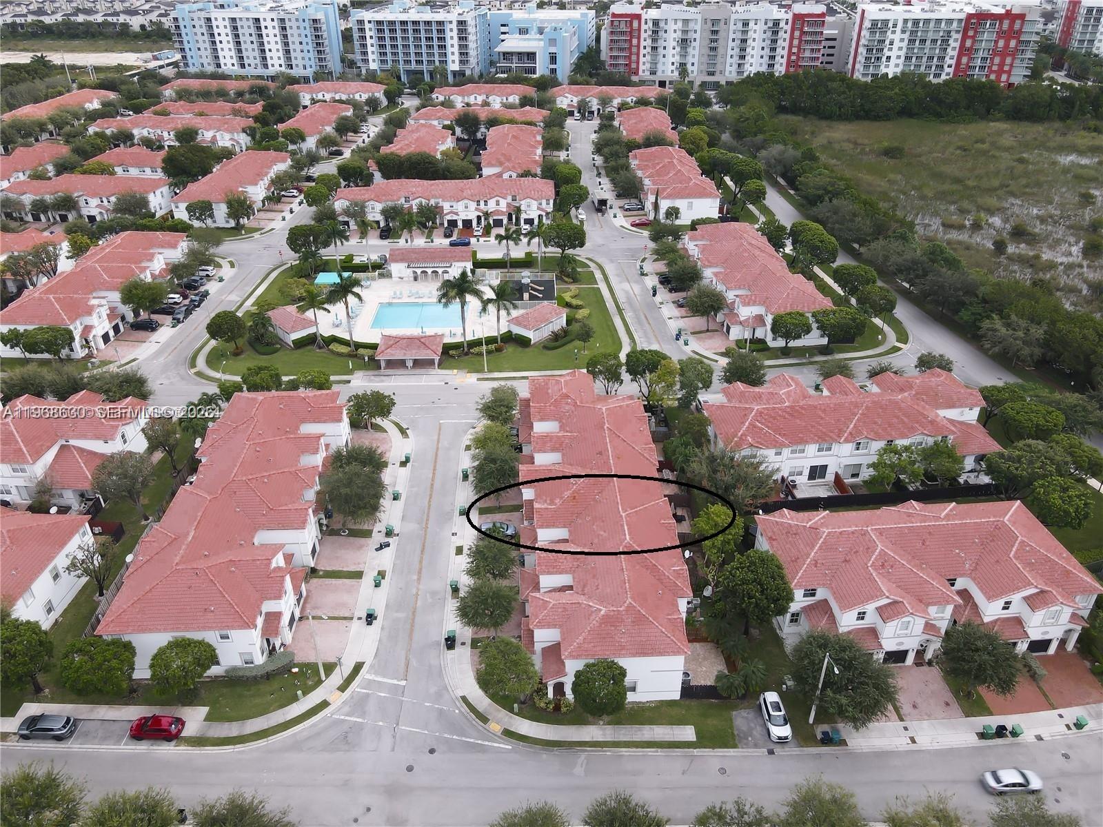 An aerial view shows a residential community with townhomes, a swimming pool, and streets — 10840 NW 79th St, Doral FL 33178, DORAL, FL