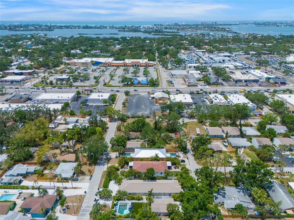 An aerial view shows a residential neighborhood with swimming pools near a commercial shopping center — 2051 ROSELAWN STREET, SARASOTA, FL