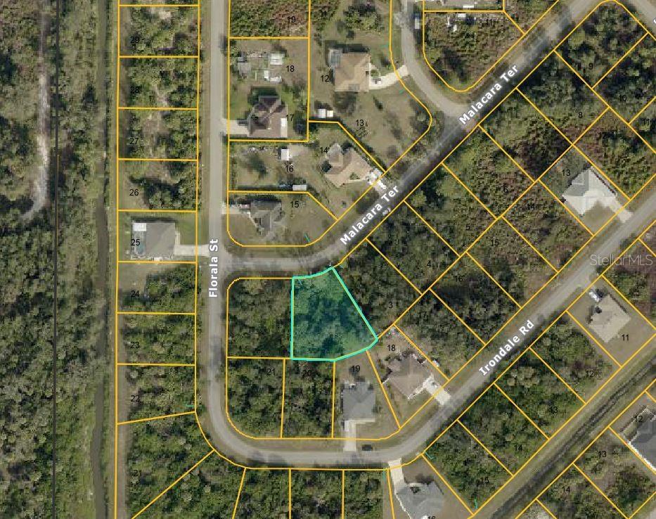 This is an aerial map showing a vacant lot highlighted in blue near residential streets — MALACARA TERRACE, NORTH PORT, FL