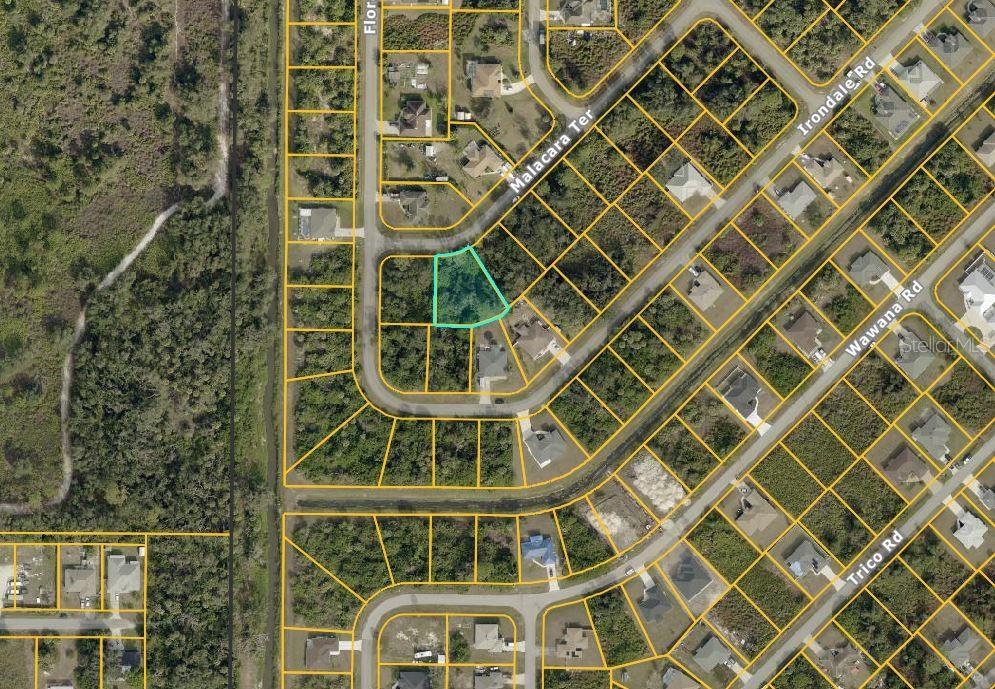This is an aerial map showing a highlighted vacant residential lot in a suburban neighborhood — MALACARA TERRACE, NORTH PORT, FL