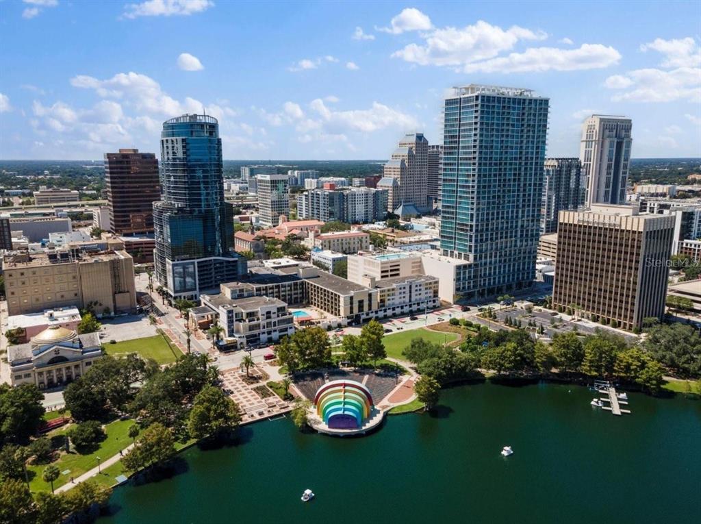 An aerial view of a city skyline featuring a lake, a park, and a rainbow amphitheater — 150 E ROBINSON STREET UNIT 29B, ORLANDO, FL