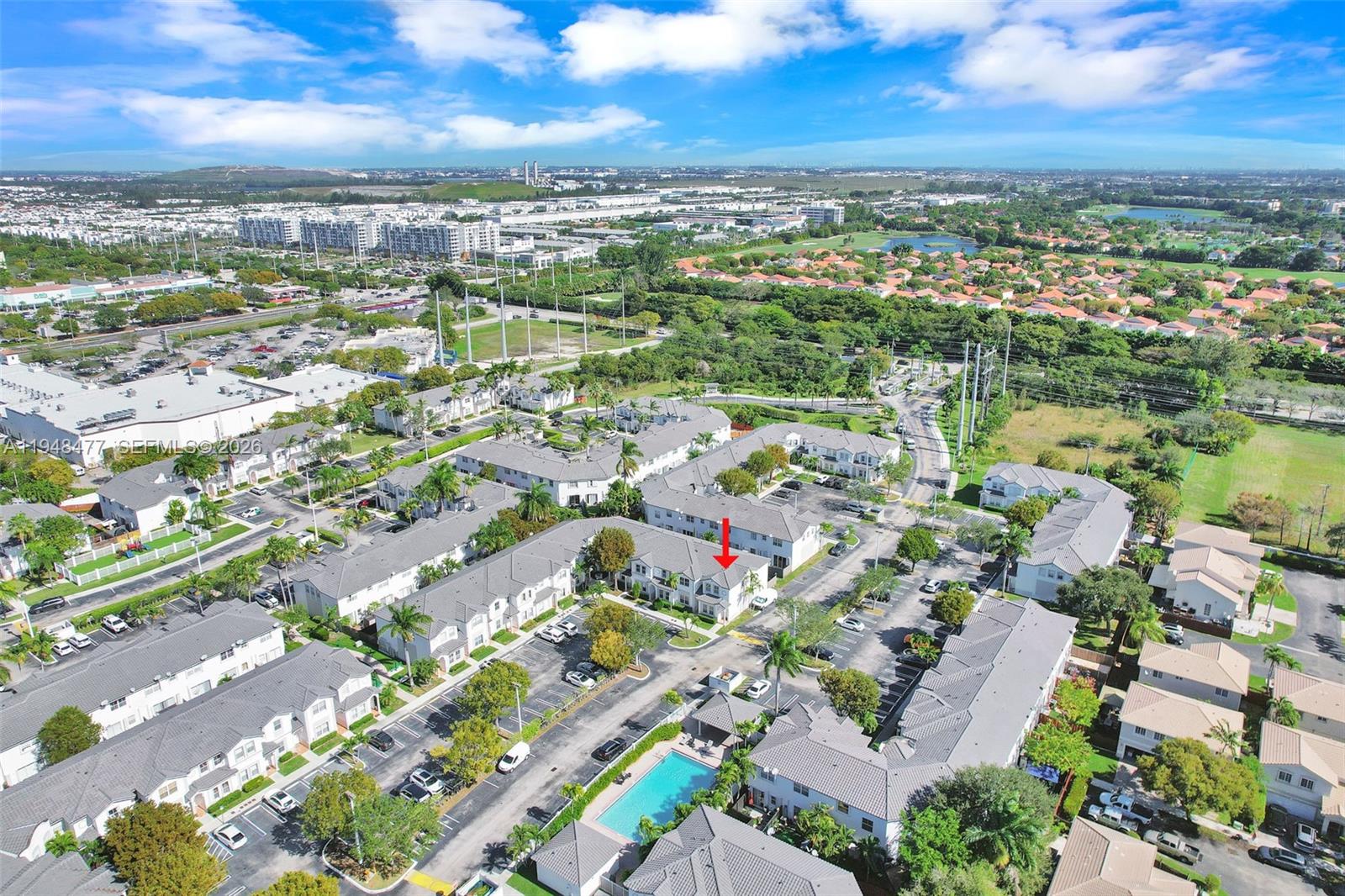 An aerial view shows a residential townhouse complex with a swimming pool and parking lots — 5420 NW 107 AVE # 302, Doral FL 33178, DORAL, FL