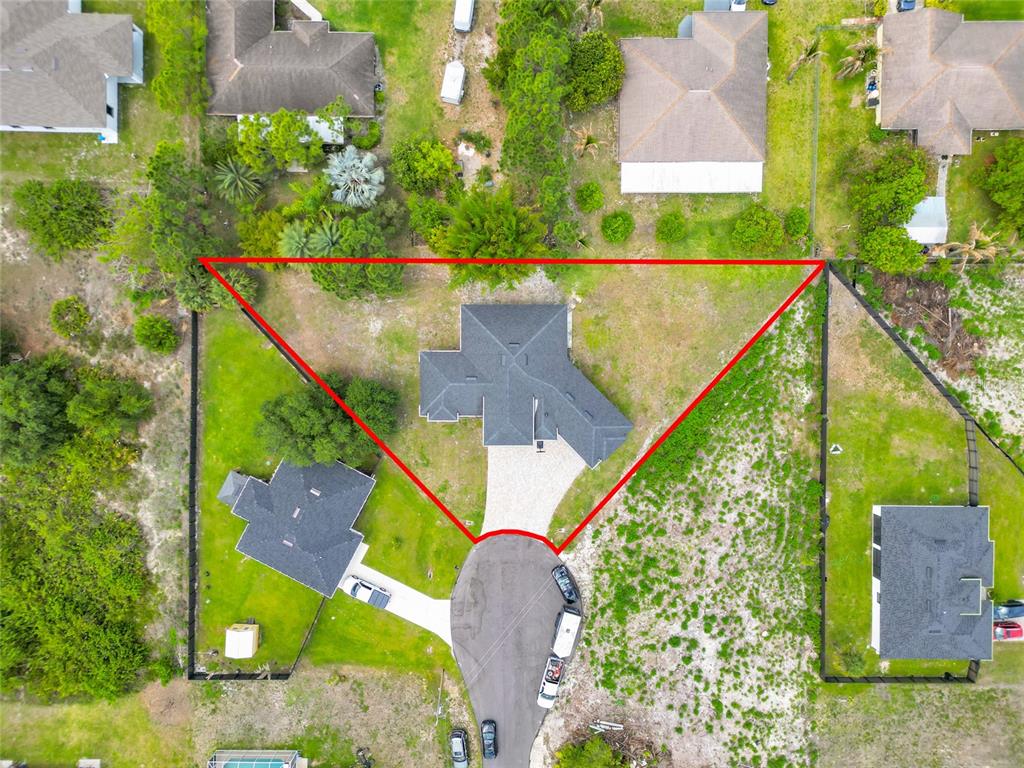 An aerial view shows a house on a pie-shaped lot at the end of a cul-de-sac — 3510 9TH COURT W, LEHIGH ACRES, FL