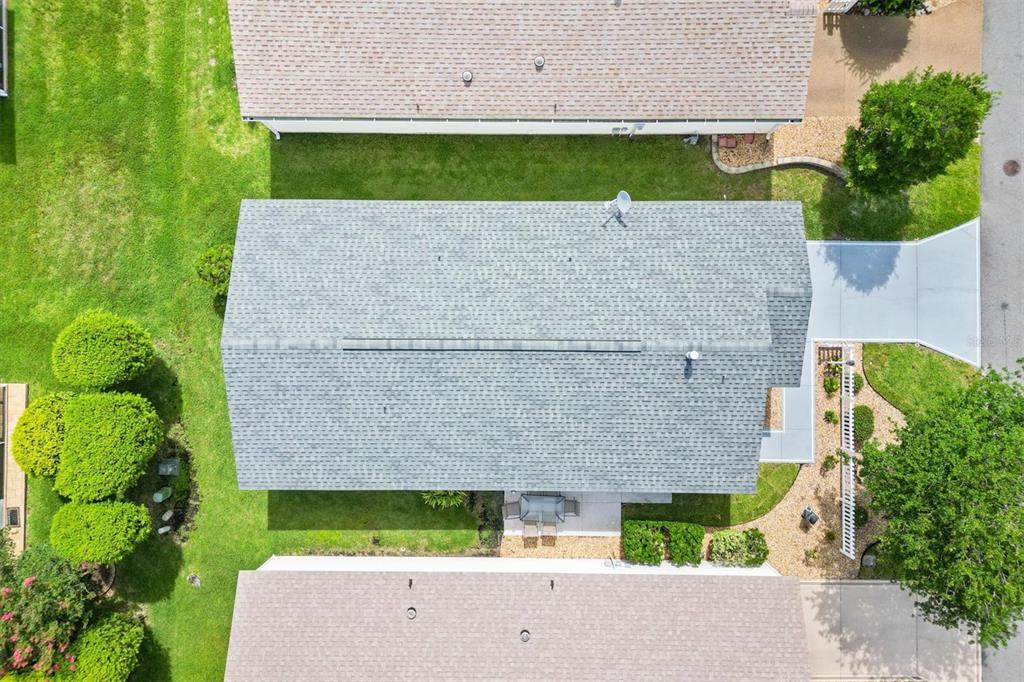 An aerial view shows a house with a gray shingled roof, lawn, and landscaping — 2752 CRAVEN WAY, THE VILLAGES, FL
