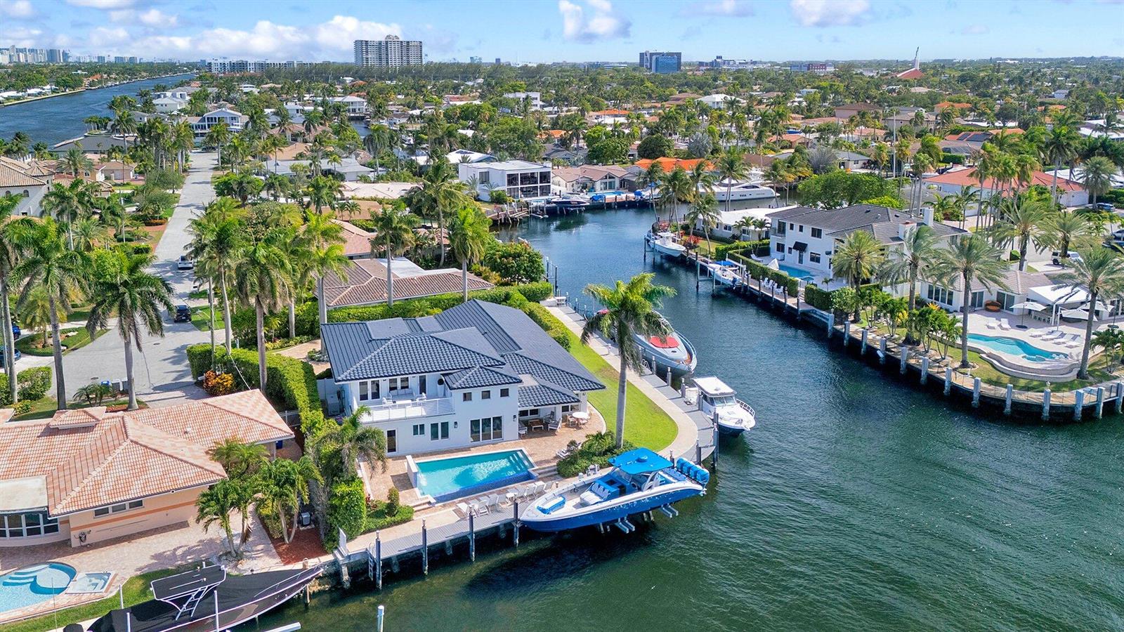 An aerial view of a waterfront house with a pool, dock, and multiple boats — 2593 SE 9th Street, Pompano Beach FL 33062, POMPANO BEACH, FL