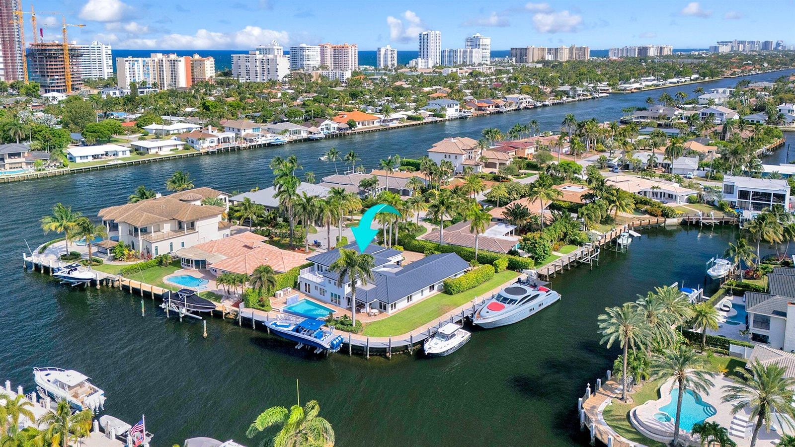 An aerial view of a waterfront house with a pool, dock, and multiple boats — 2593 SE 9th Street, Pompano Beach FL 33062, POMPANO BEACH, FL