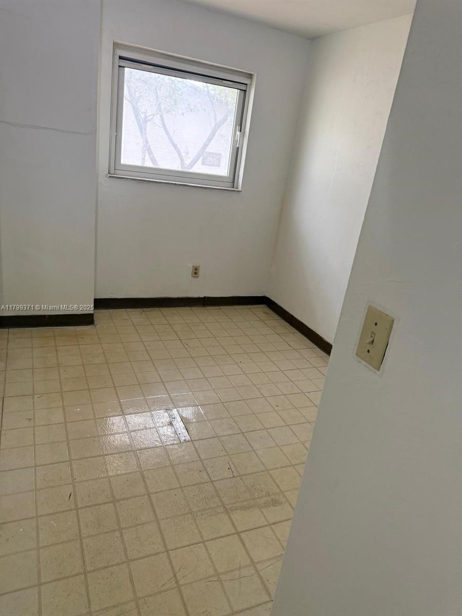 This small room features white walls, a single window, and light-colored square floor tiles — 1600 NW 4th Ave # 16A, Miami FL 33136, MIAMI, FL