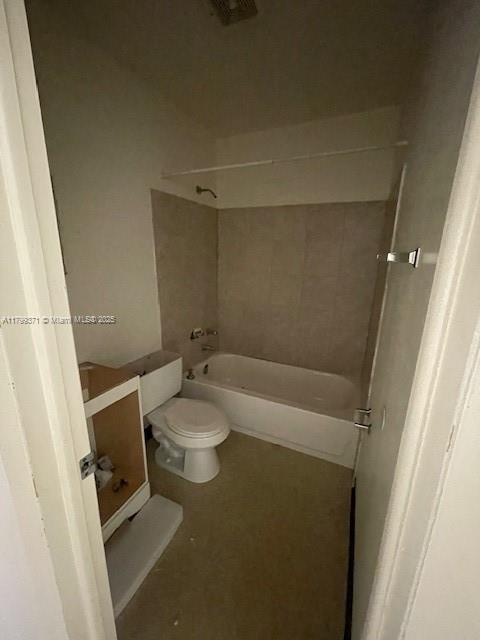 A bathroom features a white toilet, a bathtub with tiled walls, and an unfinished vanity cabinet — 1600 NW 4th Ave # 16A, Miami FL 33136, MIAMI, FL