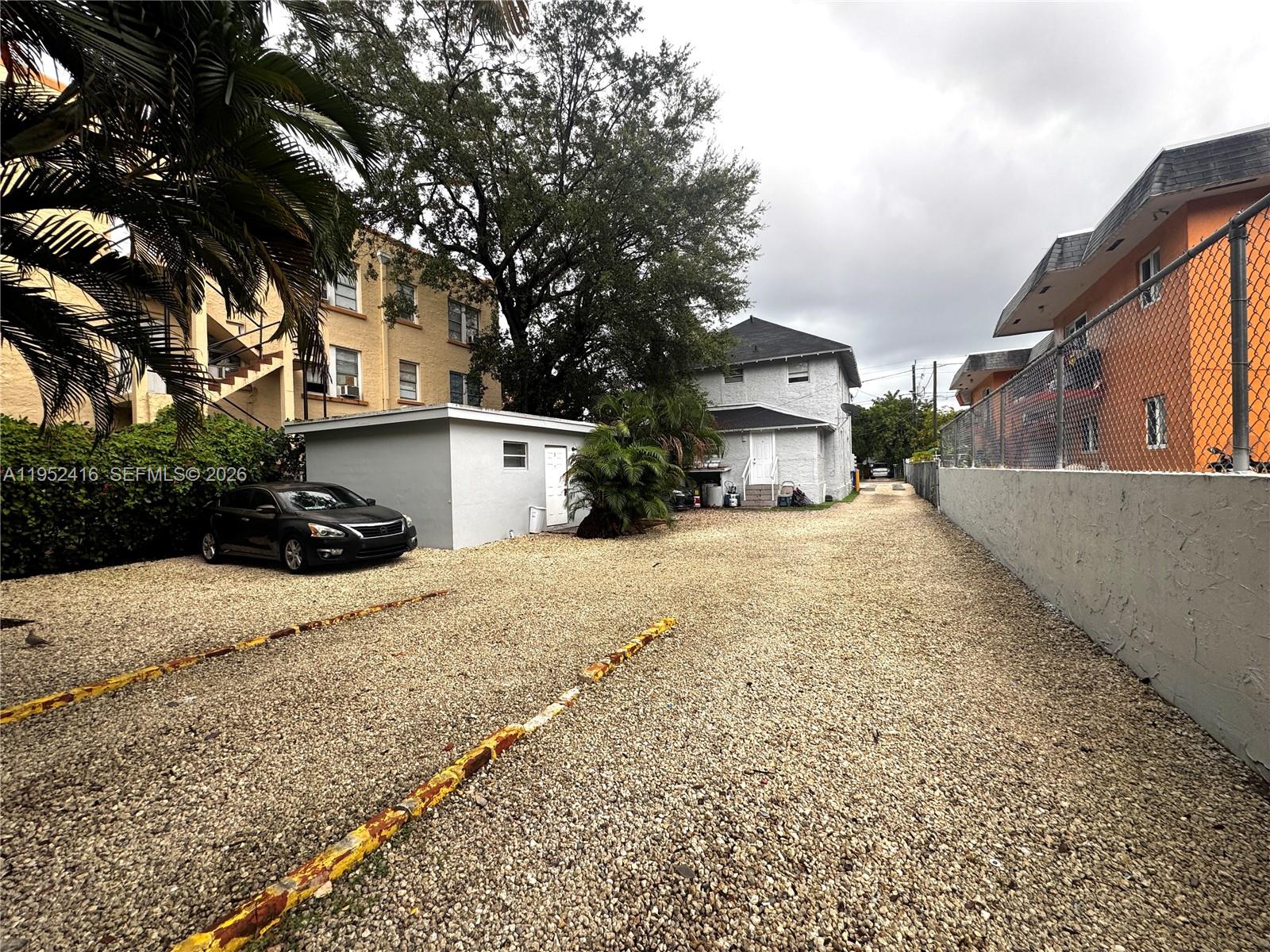 A two-story light gray house with a gravel driveway and a small front porch — 529 SW 3rd St, Miami FL 33130, MIAMI, FL