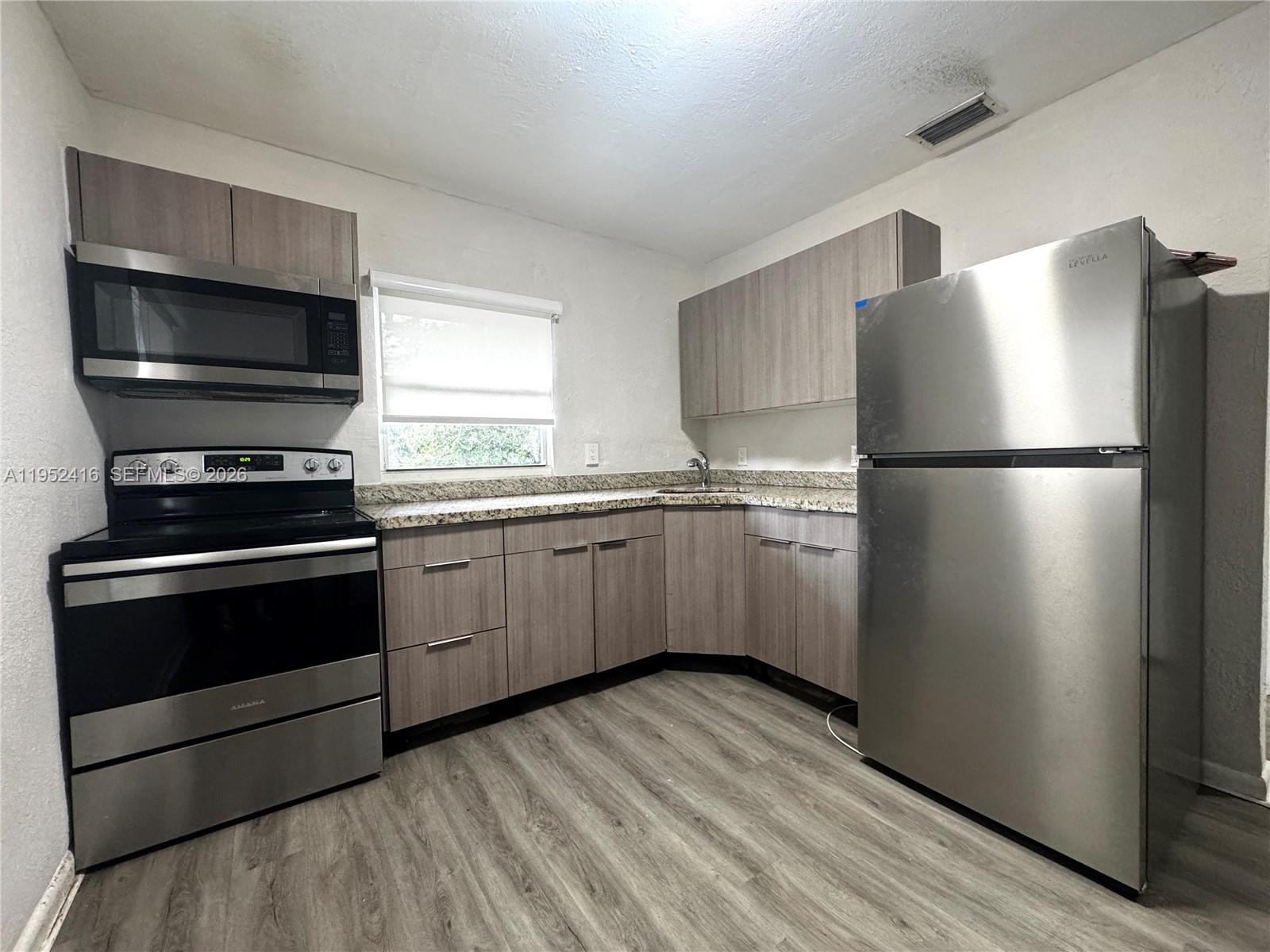 A gravel parking lot sits between two apartment buildings and a small detached structure — 529 SW 3rd St, Miami FL 33130, MIAMI, FL