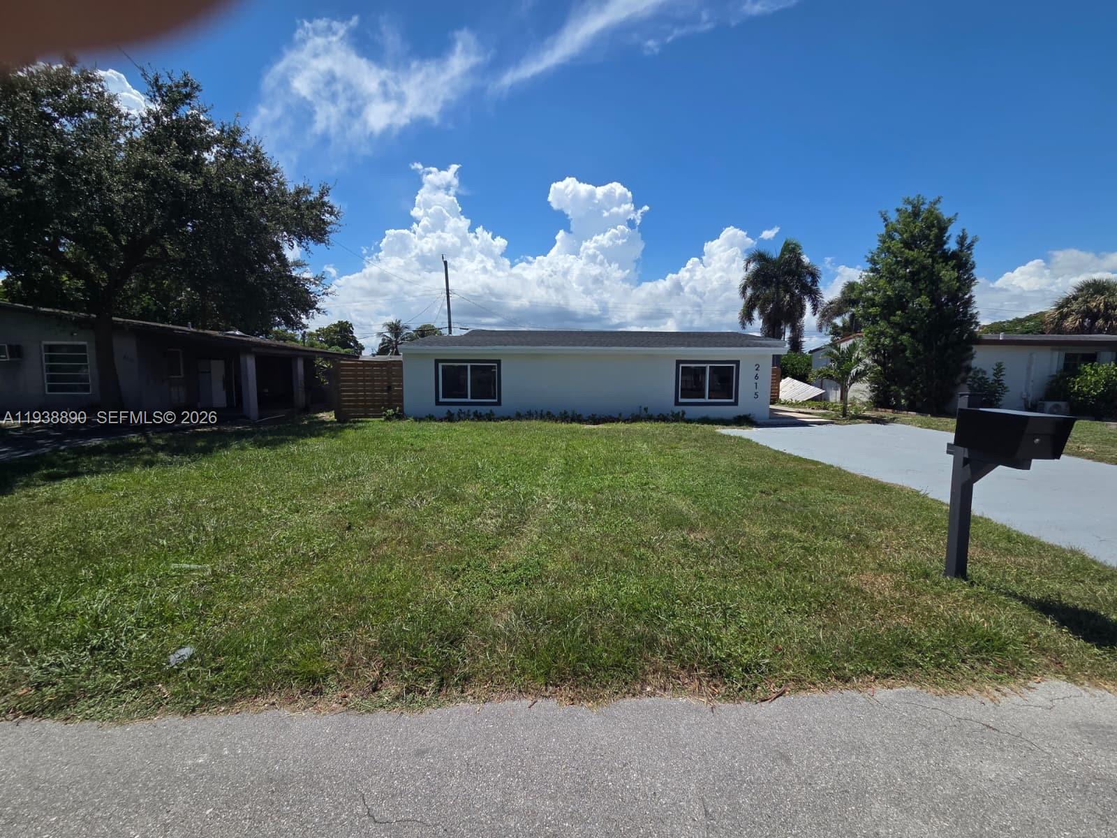 A single-story house with a white exterior, two windows, and a front lawn — 2615 NW 62nd Ave, Margate FL 33063, MARGATE, FL