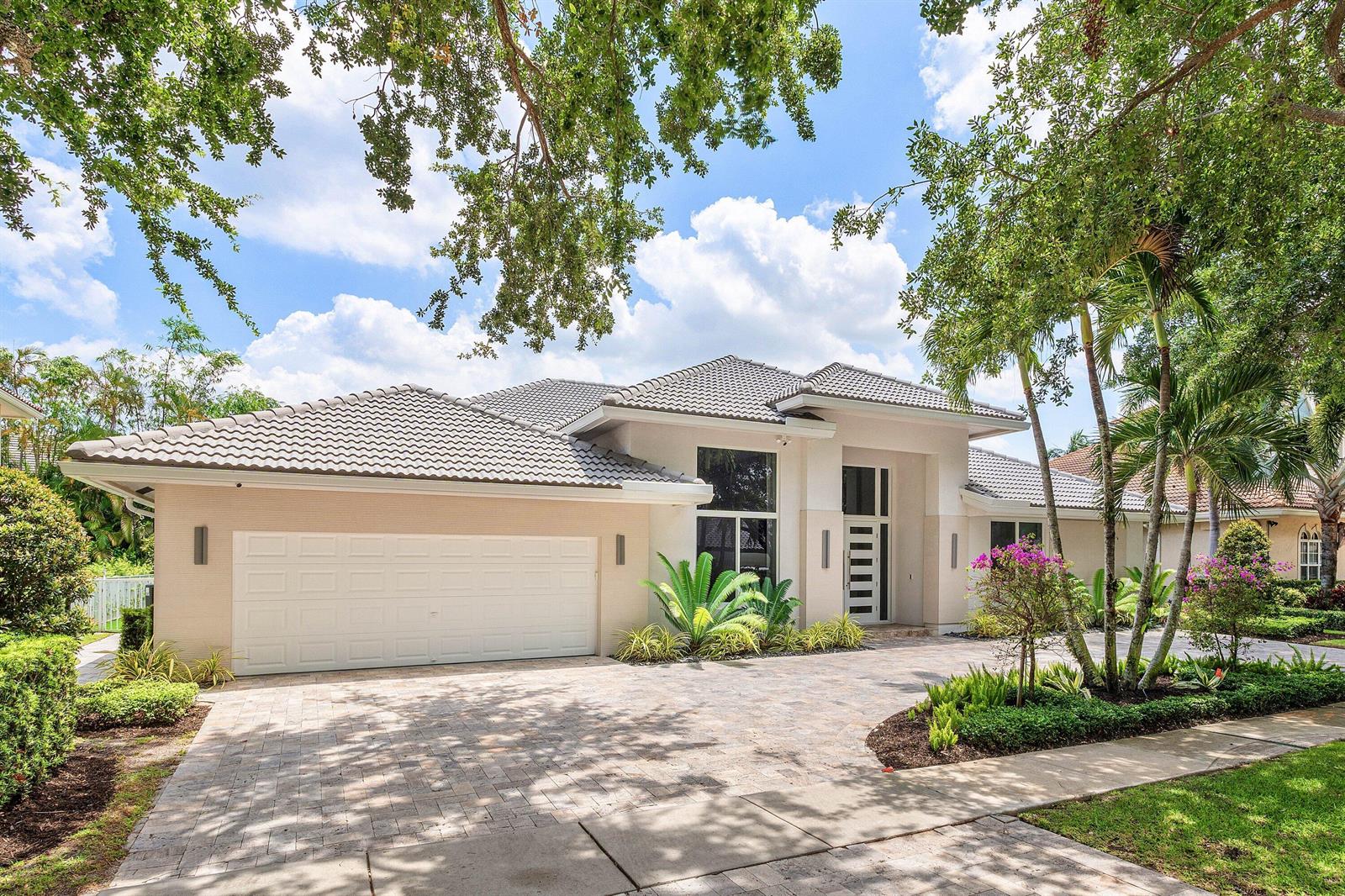 A single-story house with a beige exterior, a tiled roof, and a paved driveway — 3164 Saint Annes Drive, Boca Raton FL 33496, BOCA RATON, FL