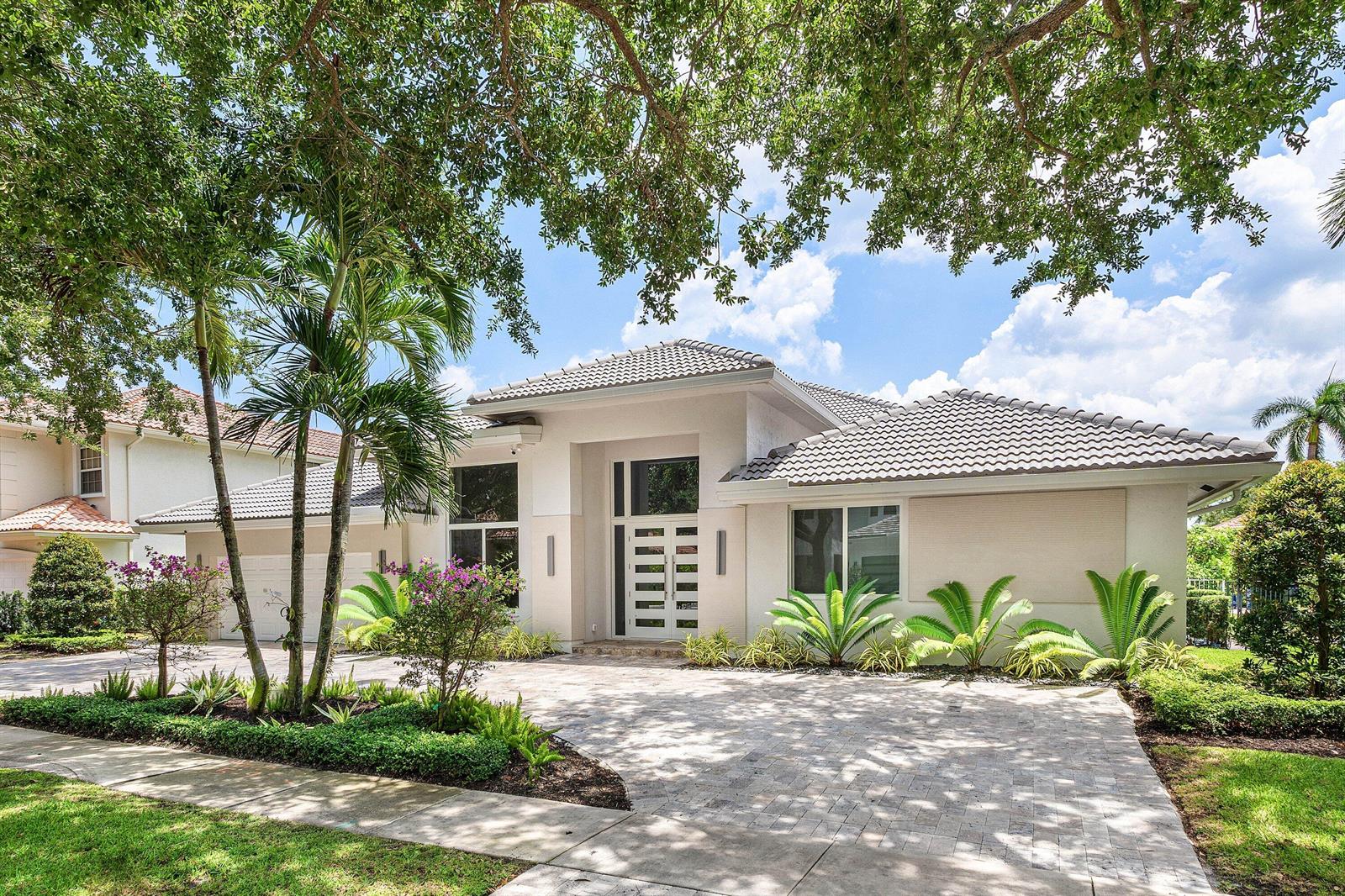 A single-story house with a tiled roof, paved driveway, and palm trees in the front yard — 3164 Saint Annes Drive, Boca Raton FL 33496, BOCA RATON, FL