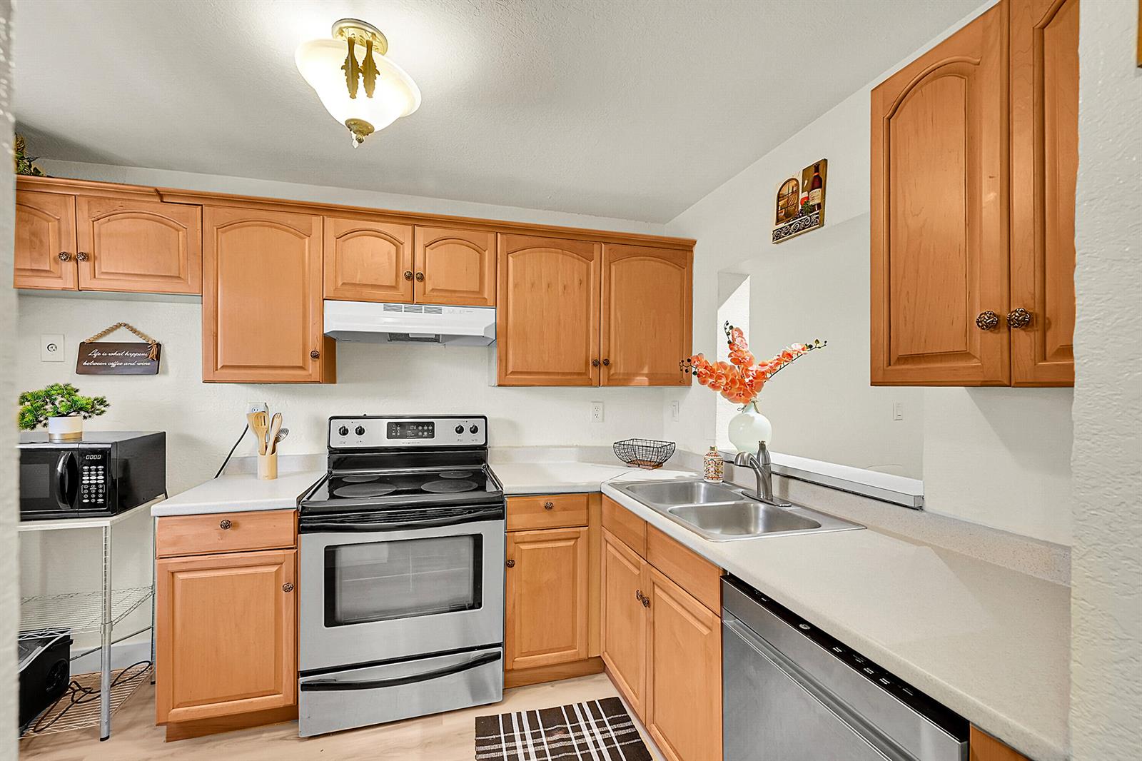 A kitchen features light wood cabinets, stainless steel appliances, and white countertops — 9503 Boca Cove Circle # 603, Boca Raton FL 33428, BOCA RATON, FL