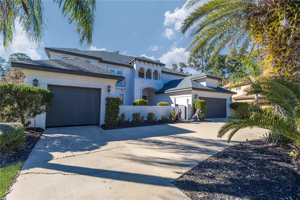 A two-story house with a multi-car garage, a concrete driveway, and palm trees — 2512 TUSCAN OAKS LANE, JACKSONVILLE, FL