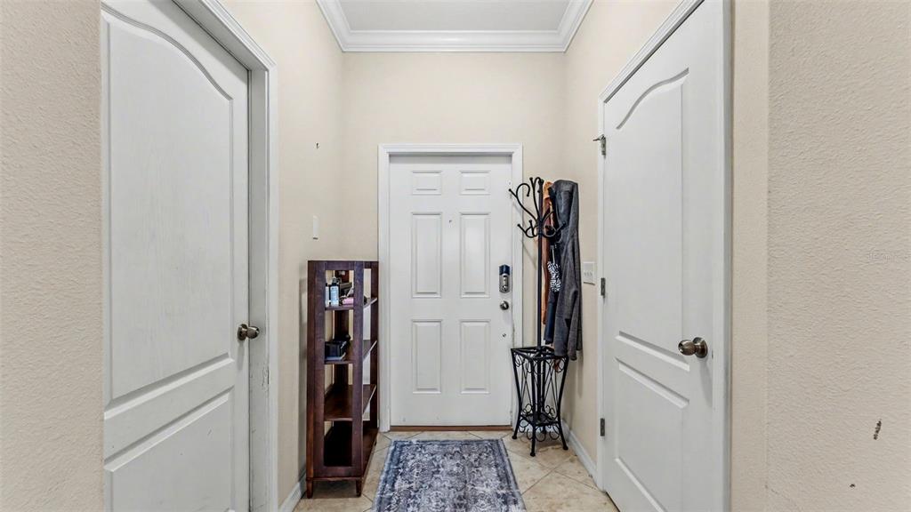 An entryway features a front door, two side doors, a coat rack, and shelving — 6441 TORRINGTON CIRCLE, LAKELAND, FL