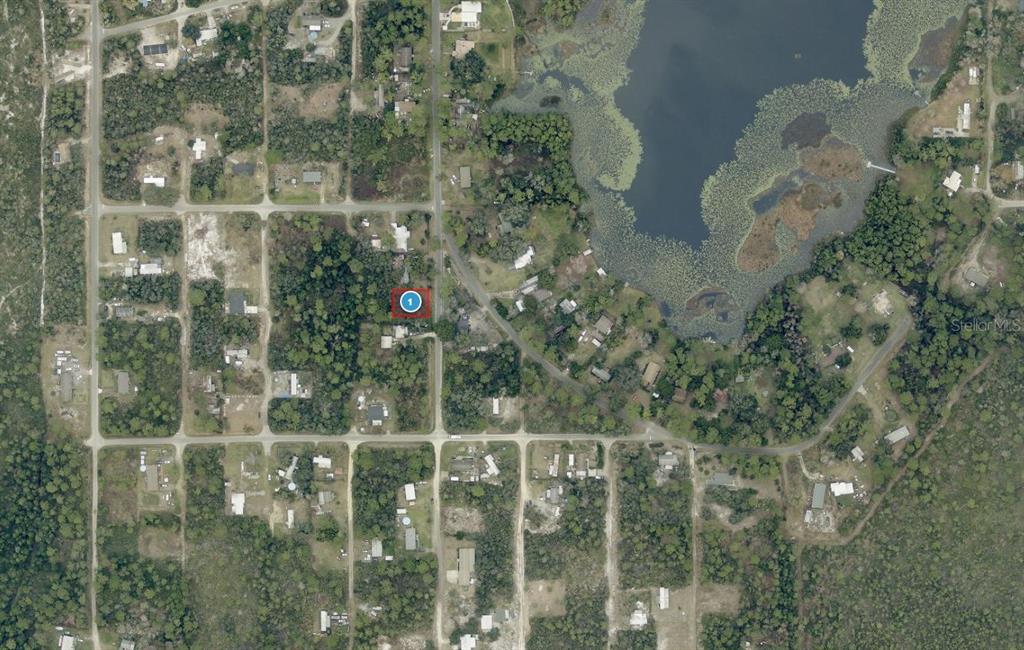 This aerial map shows a residential lot marked with a red circle near a lake — 15-17-28-0100-021-00900 PENNSYLVANIA STREET, PAISLEY, FL