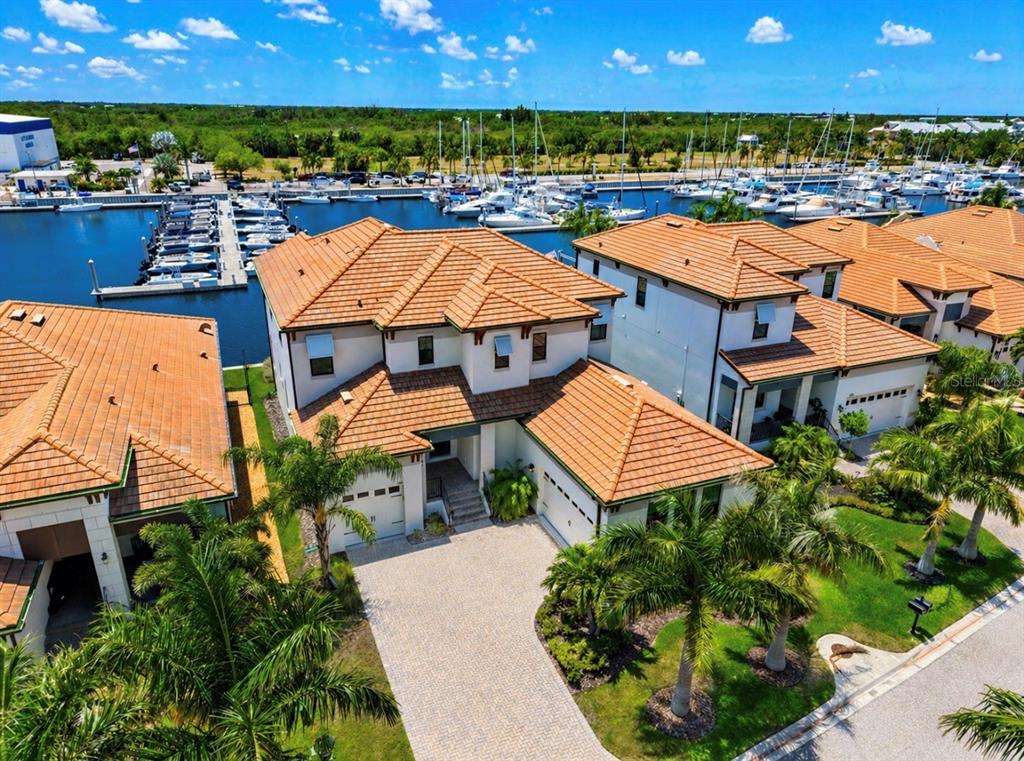 An aerial view of a multi-story house with a tile roof near a boat marina — 3016 CHRISTOPHERS WATCH LANE, RUSKIN, FL