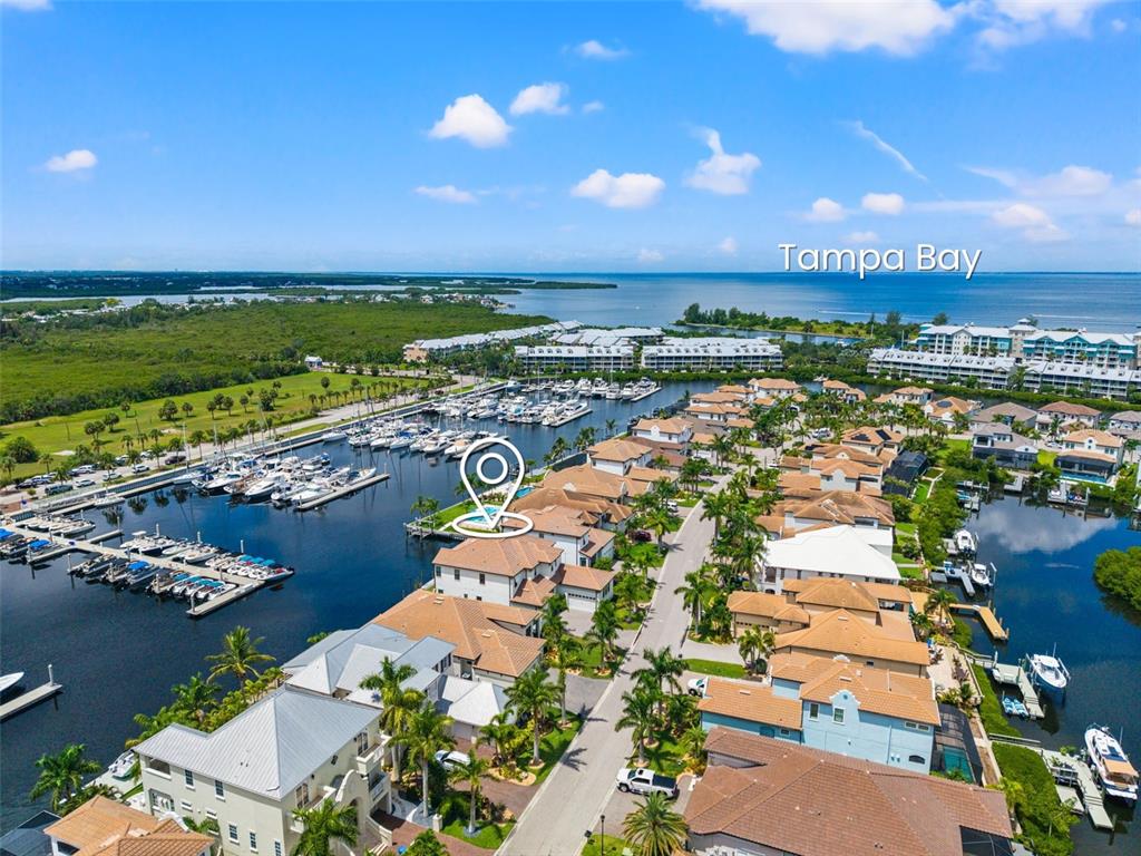 An aerial view shows waterfront homes with boat slips along a canal near Tampa Bay — 3016 CHRISTOPHERS WATCH LANE, RUSKIN, FL