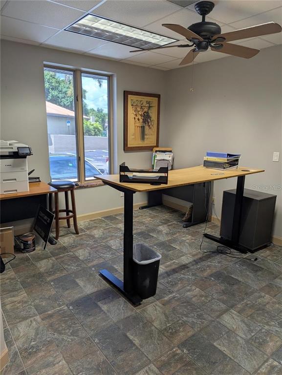 An office features a standing desk, a printer station, a ceiling fan, and tile flooring — 4456 TAMIAMI TRAIL, PUNTA GORDA, FL