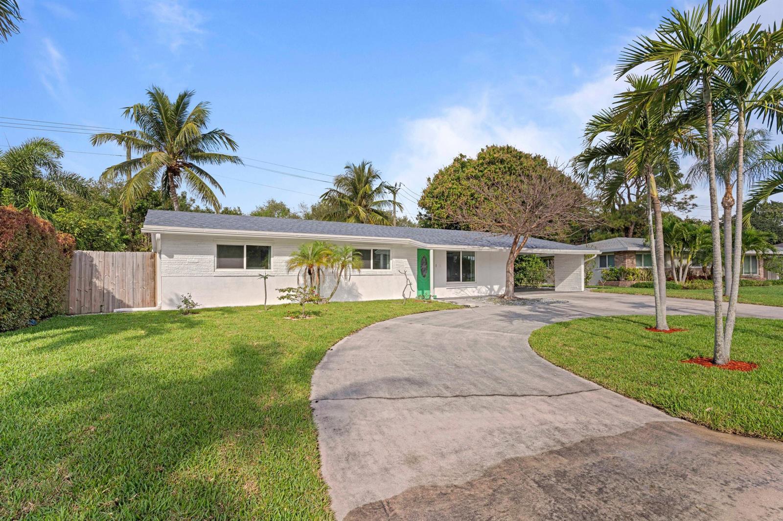 A single-story white house with a green front door and a curved concrete driveway — 2861 SW 9th Street, Boynton Beach FL 33435, BOYNTON BEACH, FL
