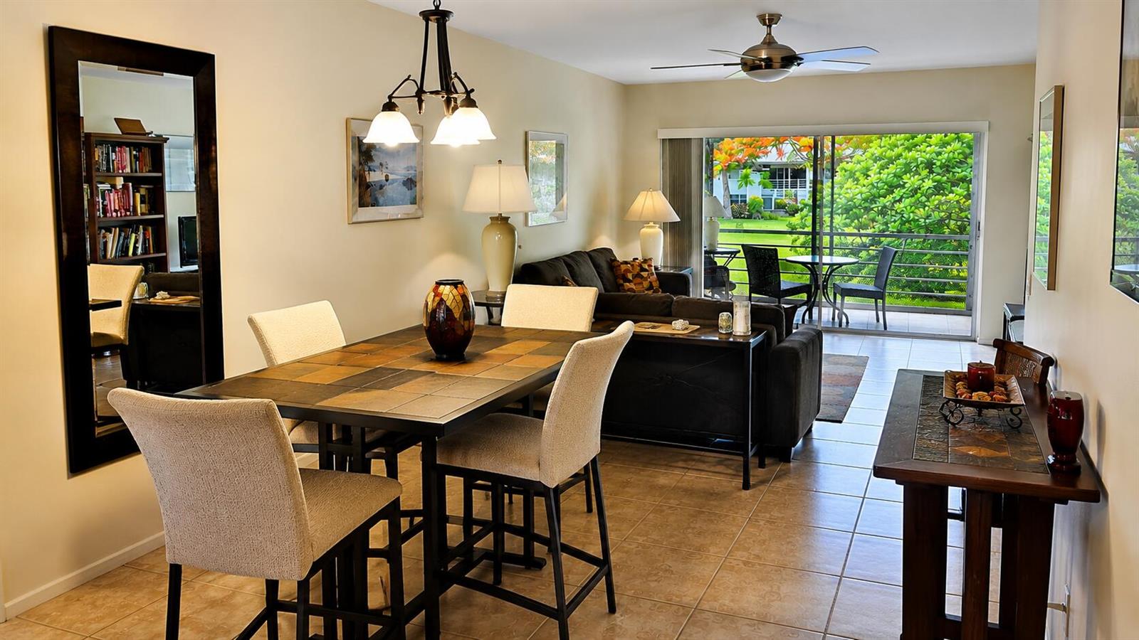 A dining area with a tiled table and chairs opens to a living room and balcony — 2620 SW 22nd Avenue # 1004, Delray Beach FL 33445, DELRAY BEACH, FL