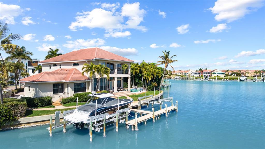 A two-story Mediterranean-style house with a tile roof, arched windows, and a paved driveway — 4914 59TH AVENUE S, ST PETERSBURG, FL