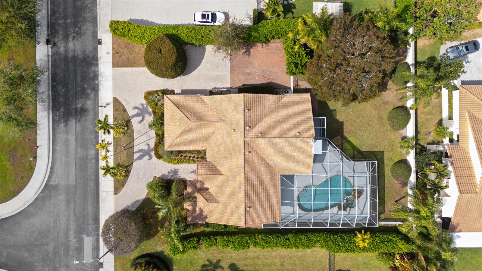 An aerial view shows a house with a tiled roof, a screened pool, and landscaping — 2730 Tecumseh Drive, West Palm Beach FL 33409, WEST PALM BEACH, FL