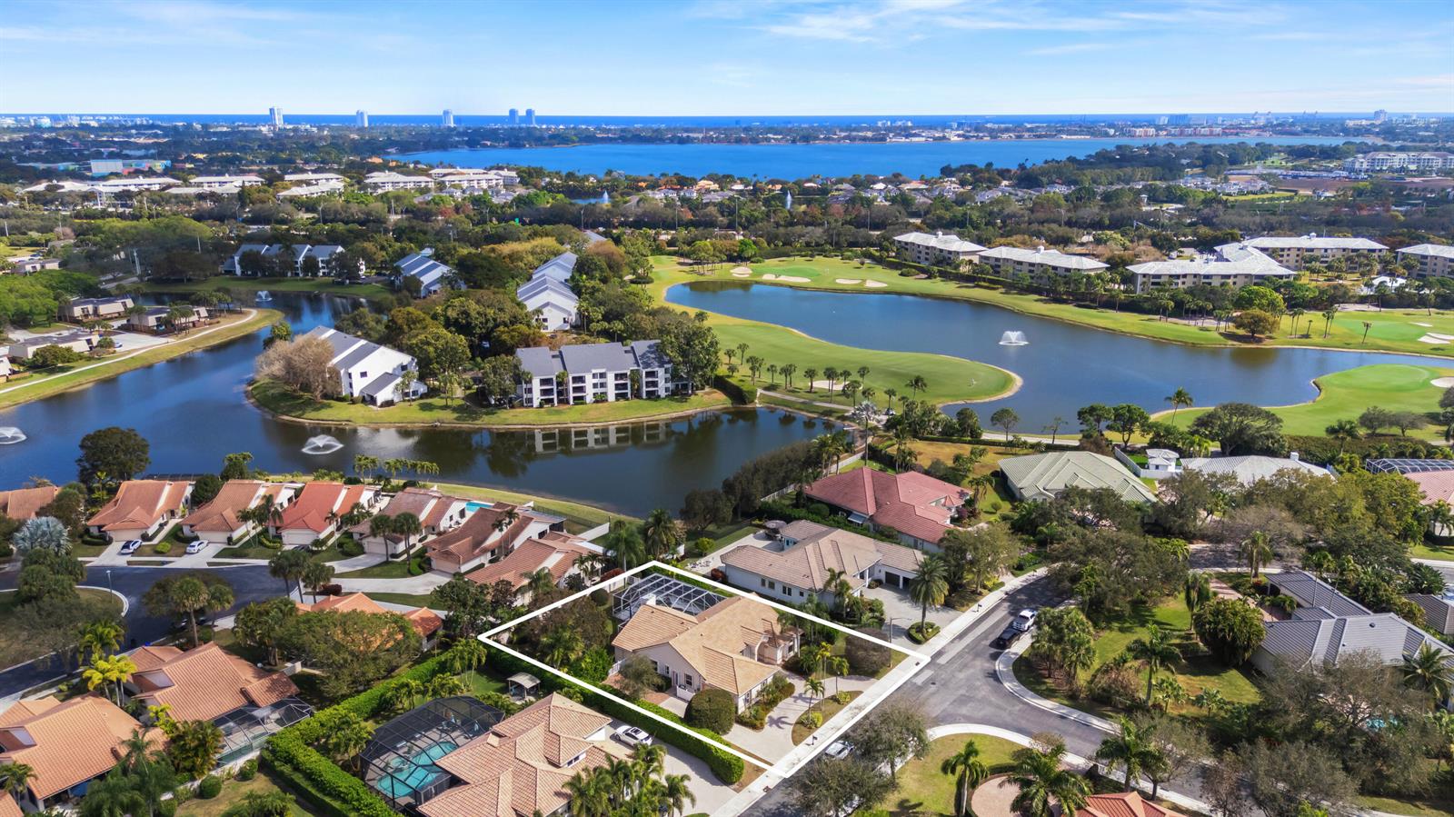 An aerial view shows a residential house with a pool cage near a golf course — 2730 Tecumseh Drive, West Palm Beach FL 33409, WEST PALM BEACH, FL