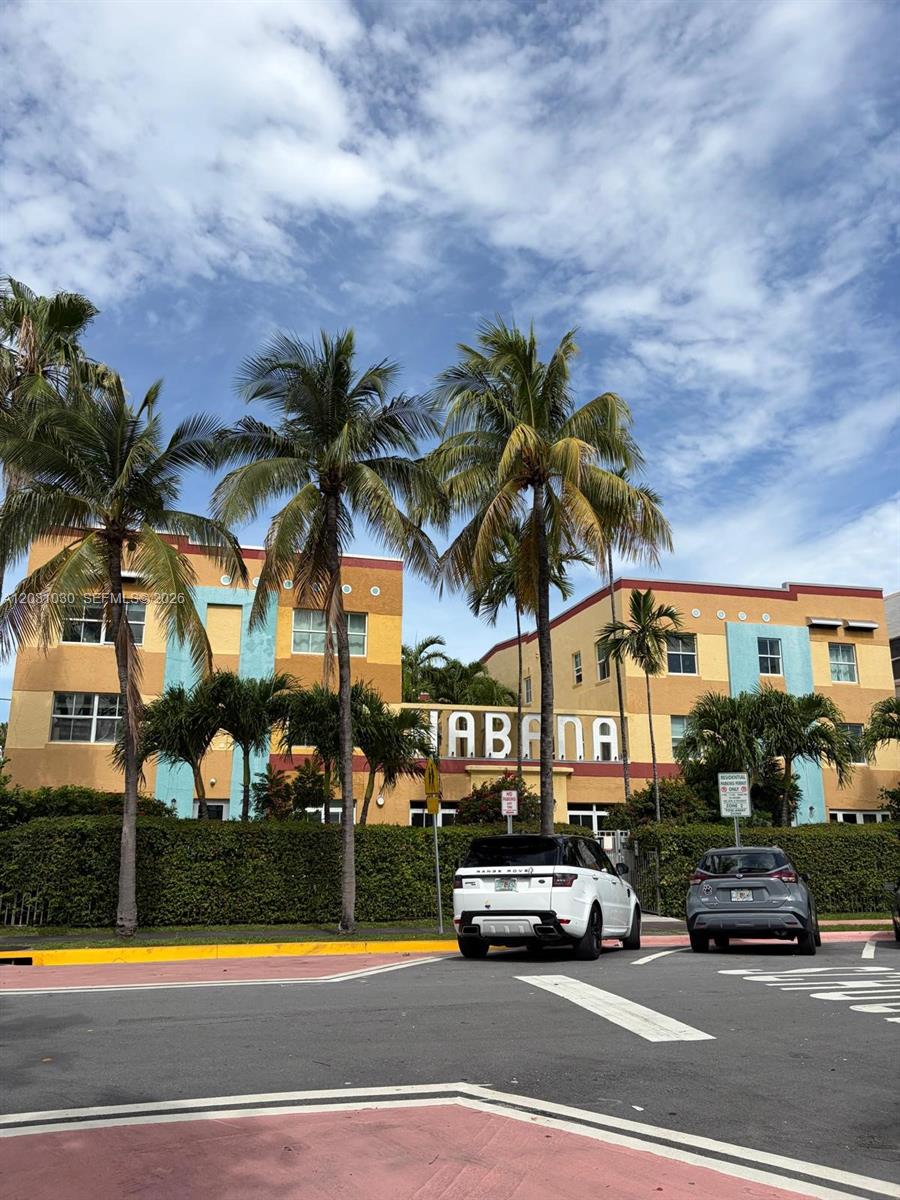 A multi-story apartment building with colorful exterior walls and palm trees in front — 1308 Drexel Ave # 311, Miami Beach FL 33139, MIAMI BEACH, FL