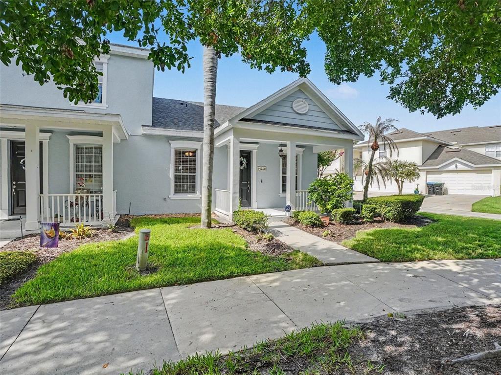 A light blue house with a front porch and a sidewalk leading to the entrance — 14250 SONCO, WINDERMERE, FL