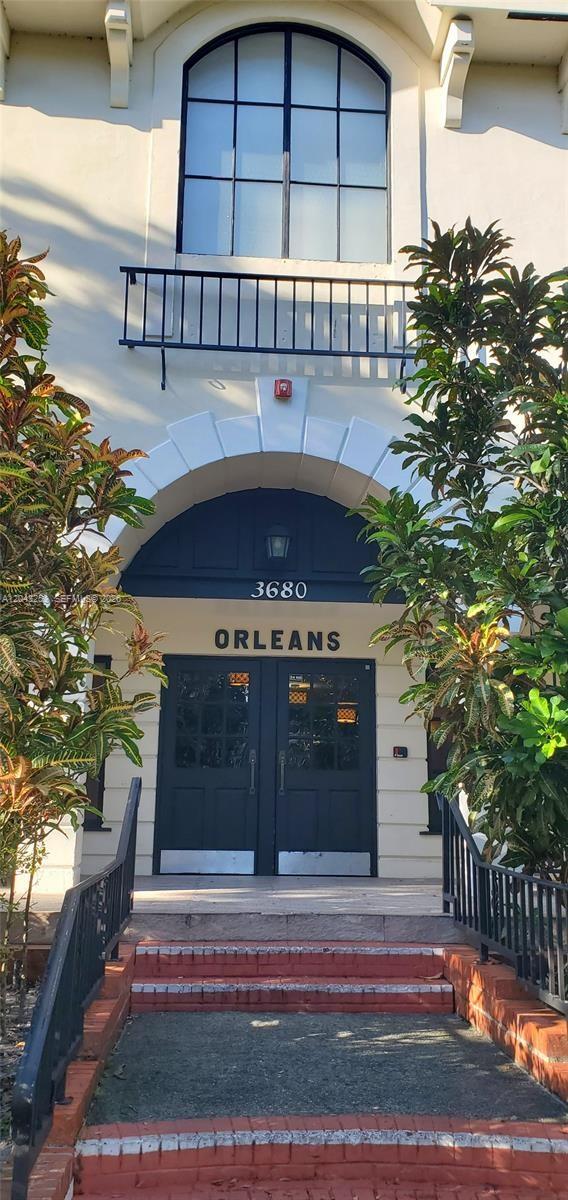 The exterior entrance features a dark double door under an arched entryway with brick steps — 3680 Inverrary Dr # 2M, Lauderhill FL 33319, LAUDERHILL, FL