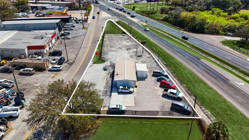 An aerial view shows a triangular commercial lot with a small building and parking area — 7116 ROSE AVENUE, ORLANDO, FL