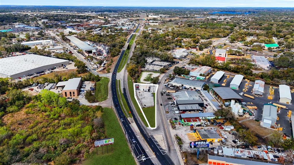 An aerial view shows a triangular lot outlined in white between two paved roads — 7116 ROSE AVENUE, ORLANDO, FL