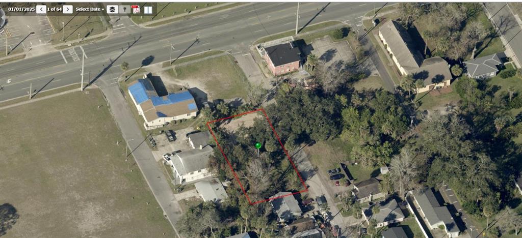 An aerial view shows a rectangular vacant lot outlined in red within a residential neighborhood — 358 FULTON STREET, DAYTONA BEACH, FL
