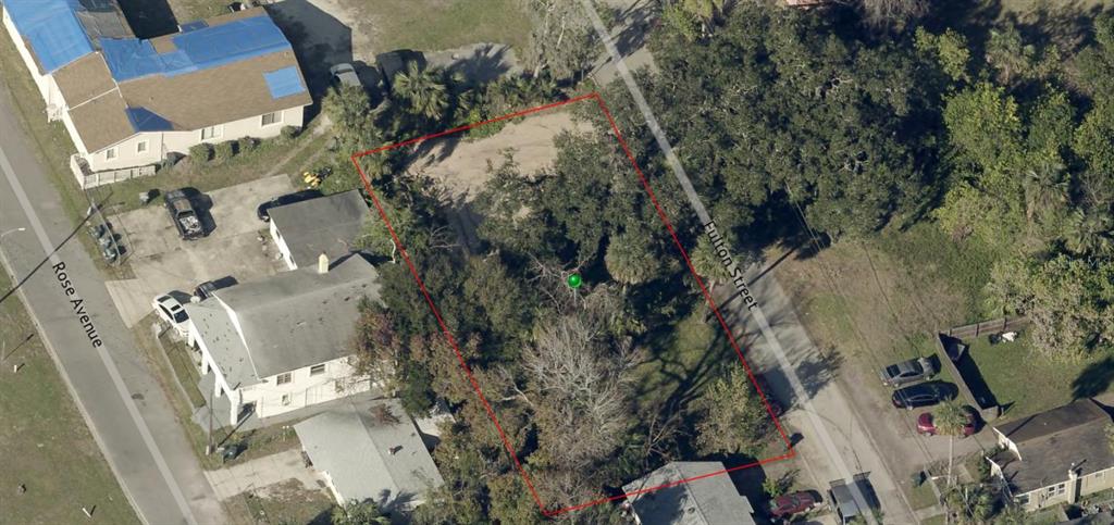 An aerial view shows a vacant, tree-covered rectangular lot outlined in red between two streets — 358 FULTON STREET, DAYTONA BEACH, FL