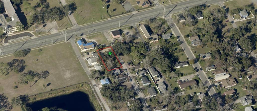 This aerial view shows a vacant, rectangular lot outlined in red within a residential neighborhood — 358 FULTON STREET, DAYTONA BEACH, FL