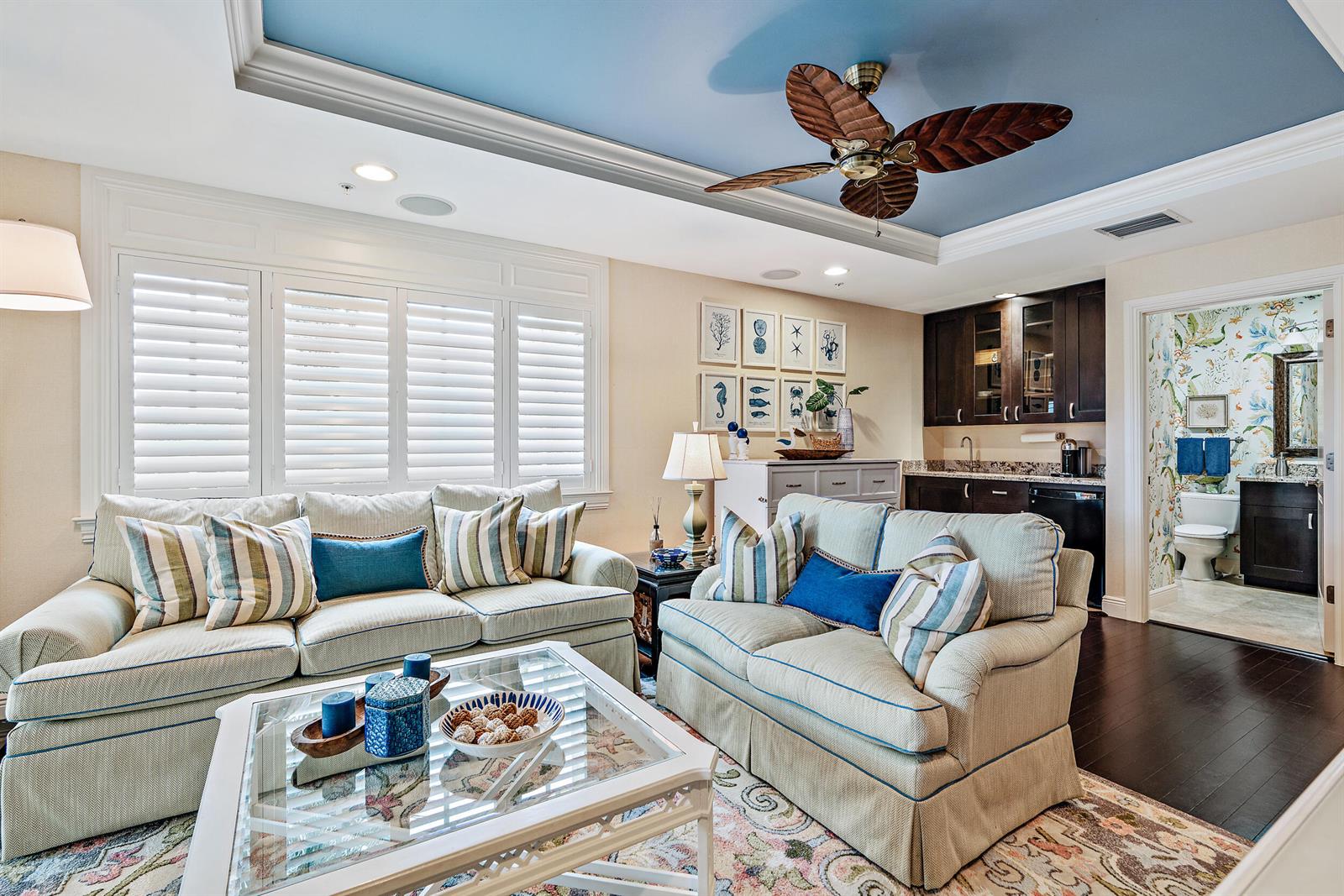 A living room features two sofas, a coffee table, a wet bar, and a blue ceiling — 126 Tierra Lane # 4, Jupiter FL 33477, JUPITER, FL