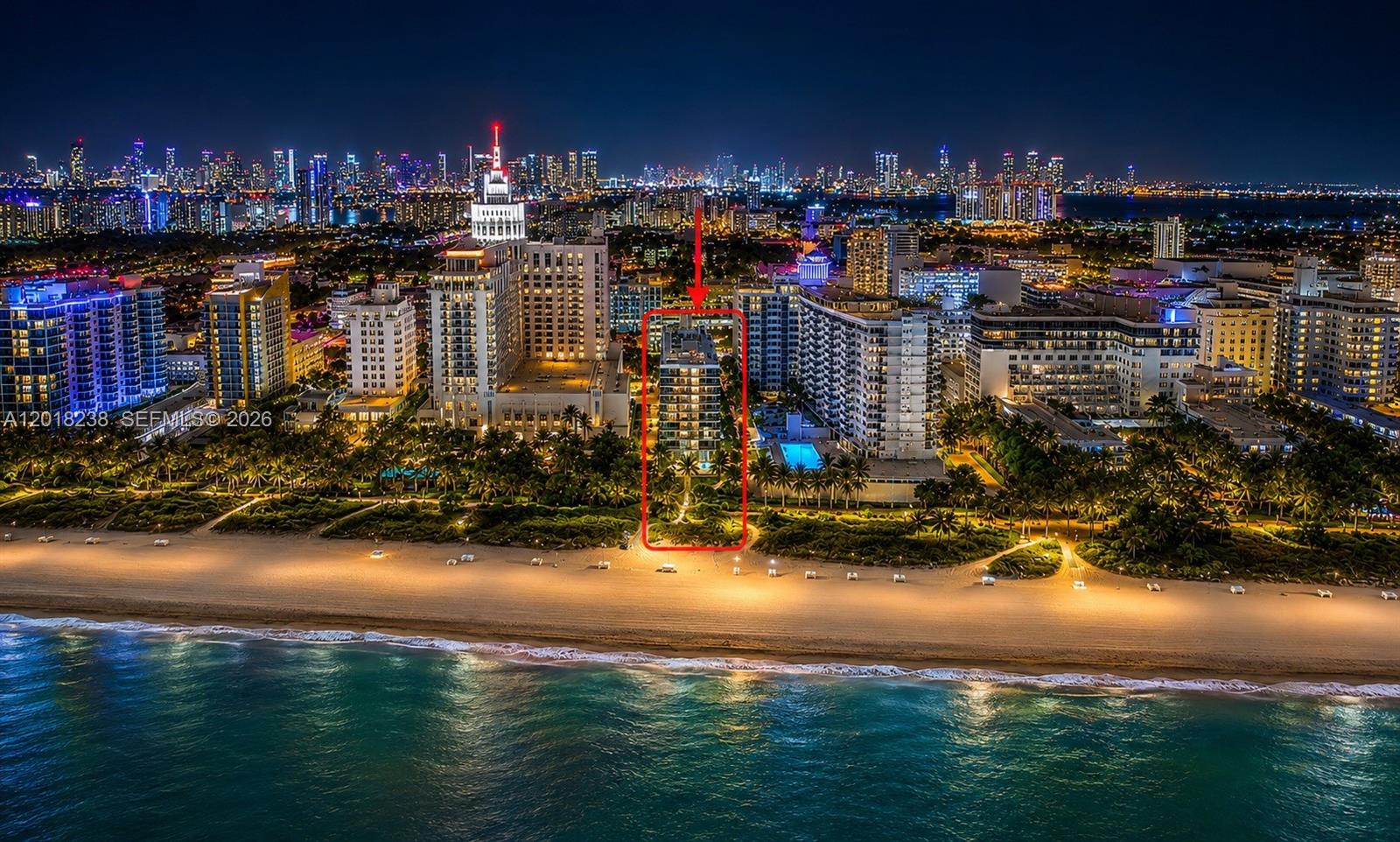 An aerial night view of a beachfront condominium building highlighted by a red box — 1621 Collins Ave # 310, Miami Beach FL 33139, MIAMI BEACH, FL
