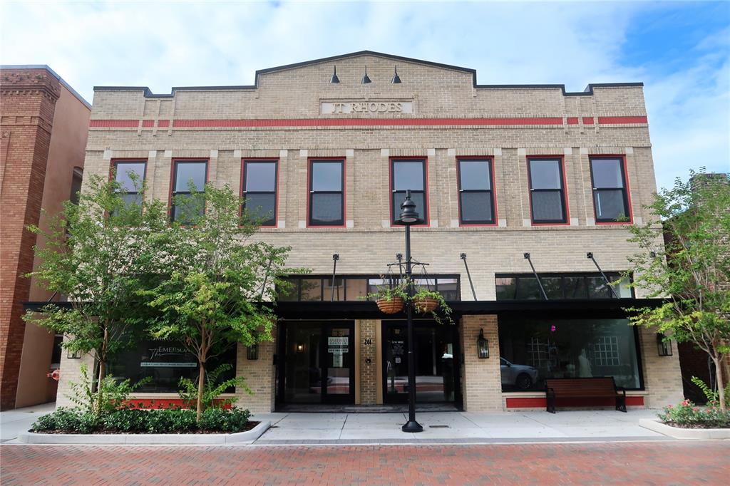 A two-story brick commercial building with large windows and a central entrance on a street — 244 E PARK AVENUE, LAKE WALES, FL