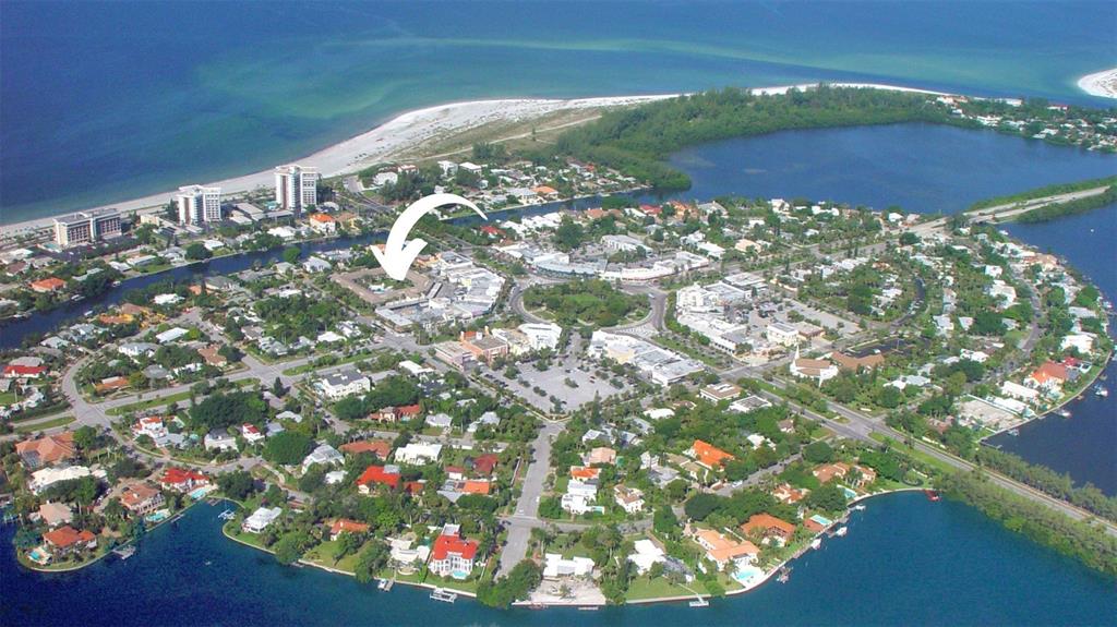 An aerial view of a coastal town with a white arrow pointing to a building — 500 S WASHINGTON DRIVE UNIT 24B, SARASOTA, FL