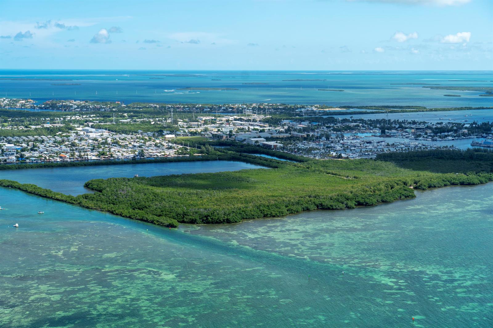 Aerial view of a coastal town with a large mangrove island and surrounding turquoise waters — 7200 5th Street, Key West FL 33040, KEY WEST, FL