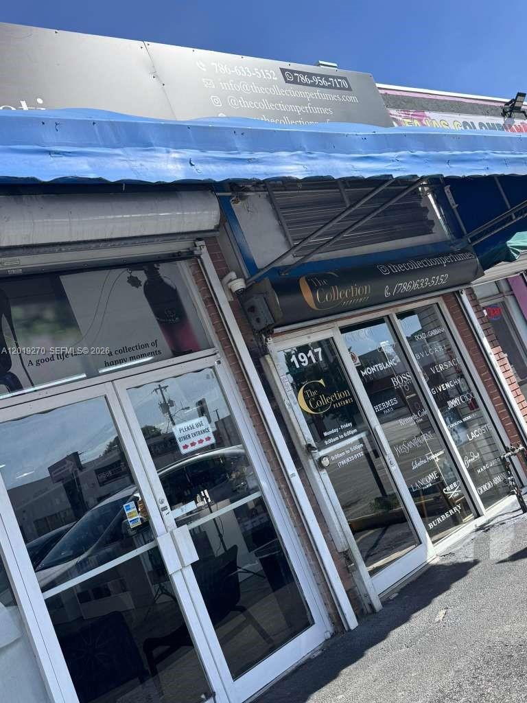 The exterior of a perfume shop features glass doors, signage, and a list of brands — 1917 NW 20th St, Miami FL 33142, MIAMI, FL
