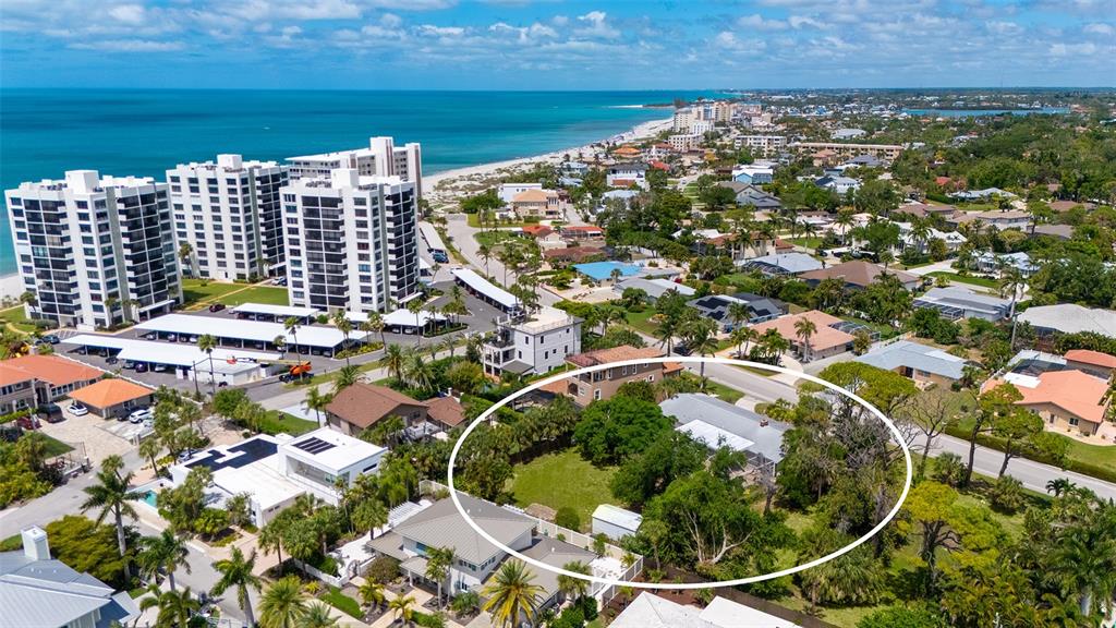 An aerial view shows a residential property circled in white amidst a coastal neighborhood — 621 ALHAMBRA ROAD, VENICE, FL