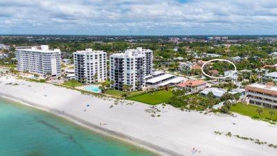 An aerial view of a beach with high-rise condominiums and surrounding residential properties — 621 ALHAMBRA ROAD, VENICE, FL
