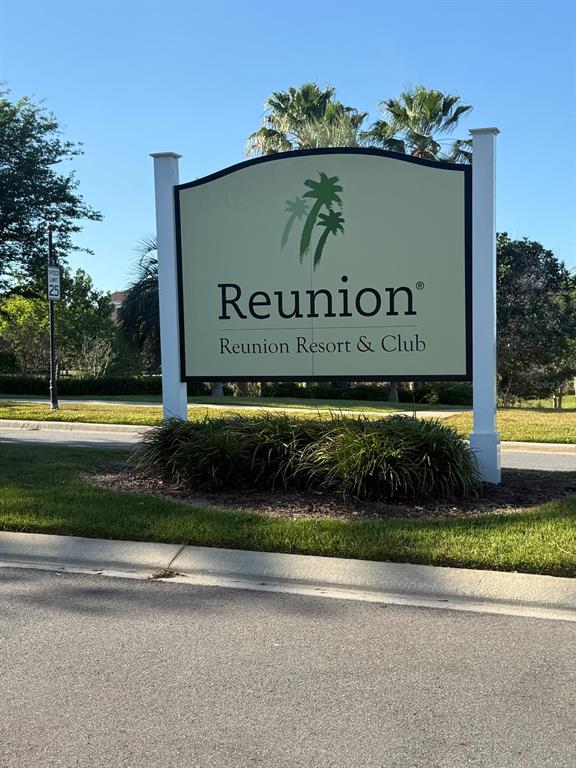A sign for Reunion Resort & Club stands in a grassy area near a road — 1100 SUNSET VIEW CIRCLE S UNIT 304, KISSIMMEE, FL