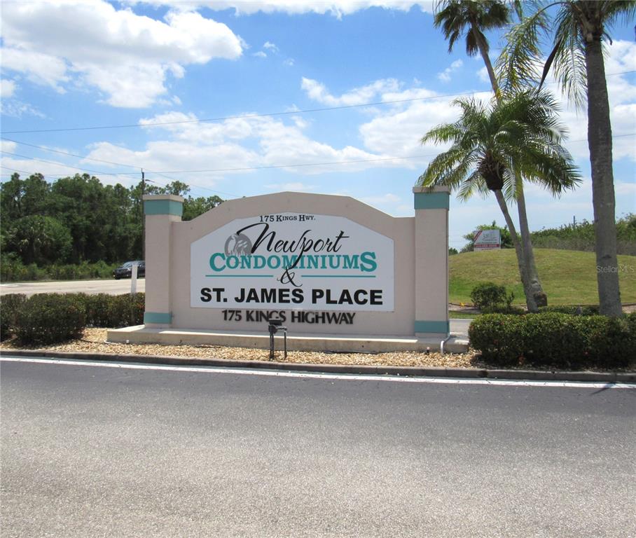 A sign for Newport Condominiums and St. James Place stands beside a road and palm trees — 175 KINGS HIGHWAY UNIT 933, PUNTA GORDA, FL