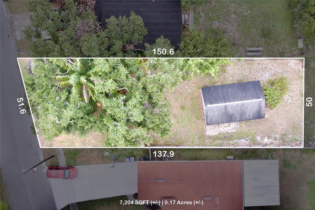 This aerial view shows a rectangular lot with a small building and trees — 1333 SUSANNAH BOULEVARD, ORLANDO, FL