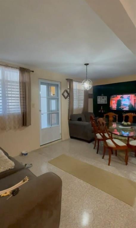 A living room features a dining area, a glass-paneled door, and a wall-mounted television — 507 VICENTA ARROYO, MANATI, PR